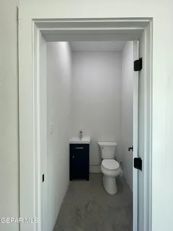 a bathroom with a toilet and a vanity