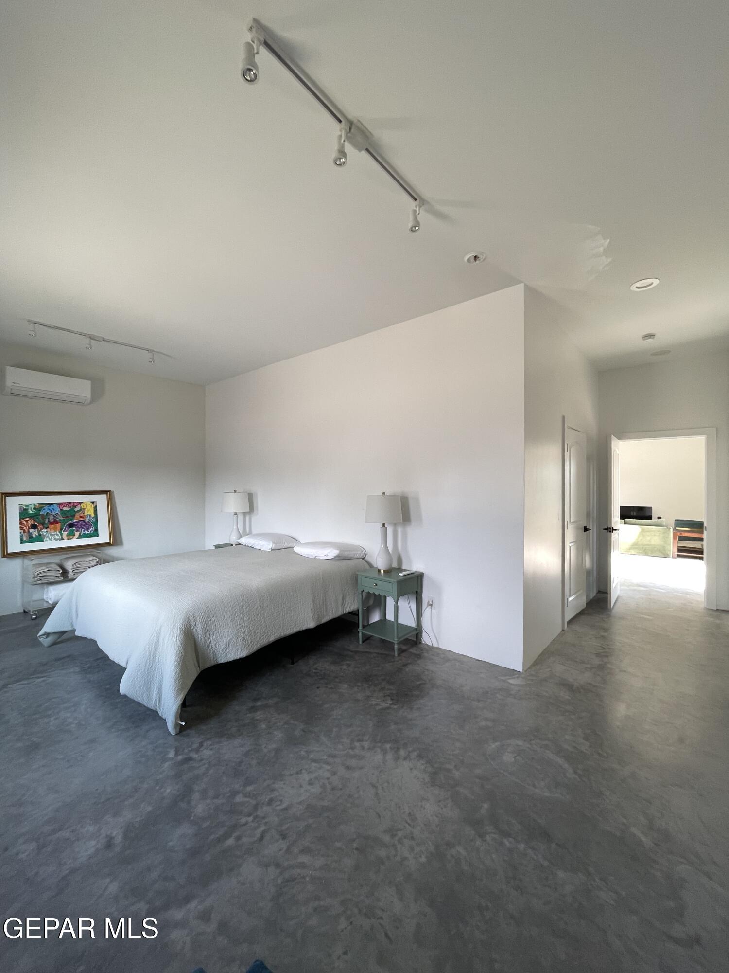 1402 Philadelphia Street Marfa, TX 79843 - Photo 9 of 11 a bed room with a bed and a couch