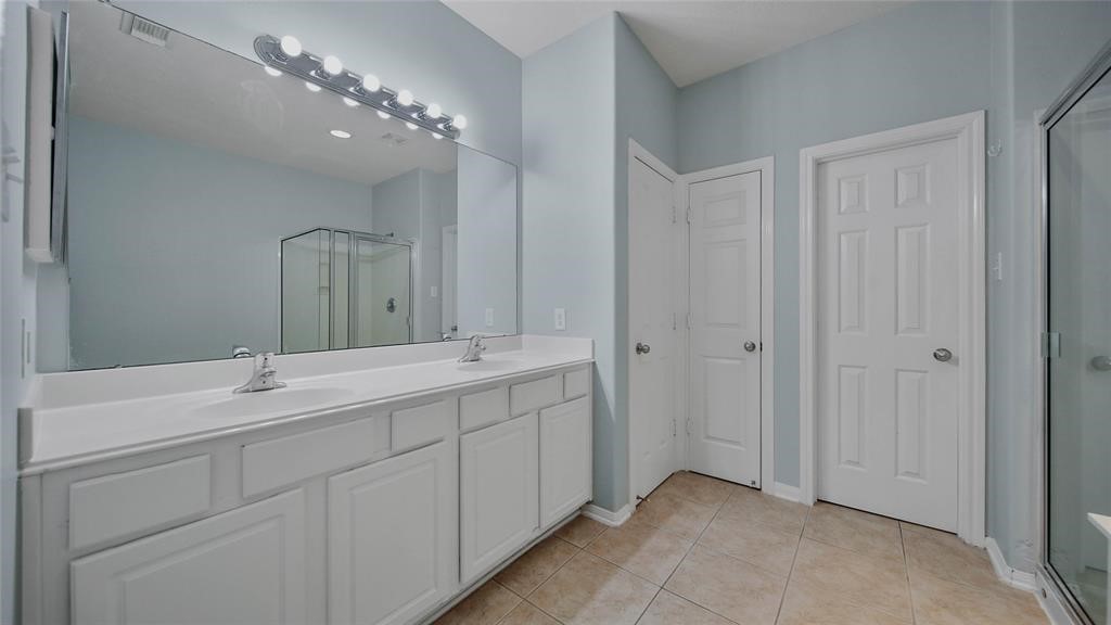87 West Twinvale Loop Conroe, TX 77384 - Photo 13 of 19 a bathroom with double vanity and a mirror