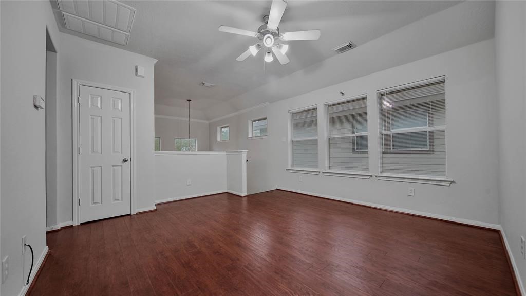 87 West Twinvale Loop Conroe, TX 77384 - Photo 16 of 19 wooden floor in an empty room with a window