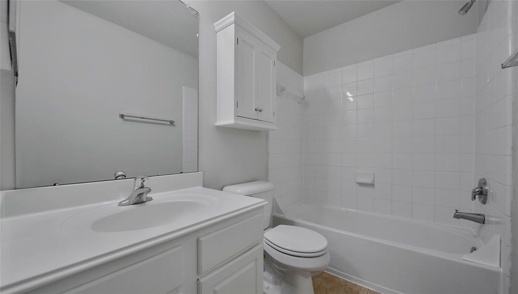 87 West Twinvale Loop Conroe, TX 77384 - Photo 18 of 19 a bathroom with a sink a toilet and shower