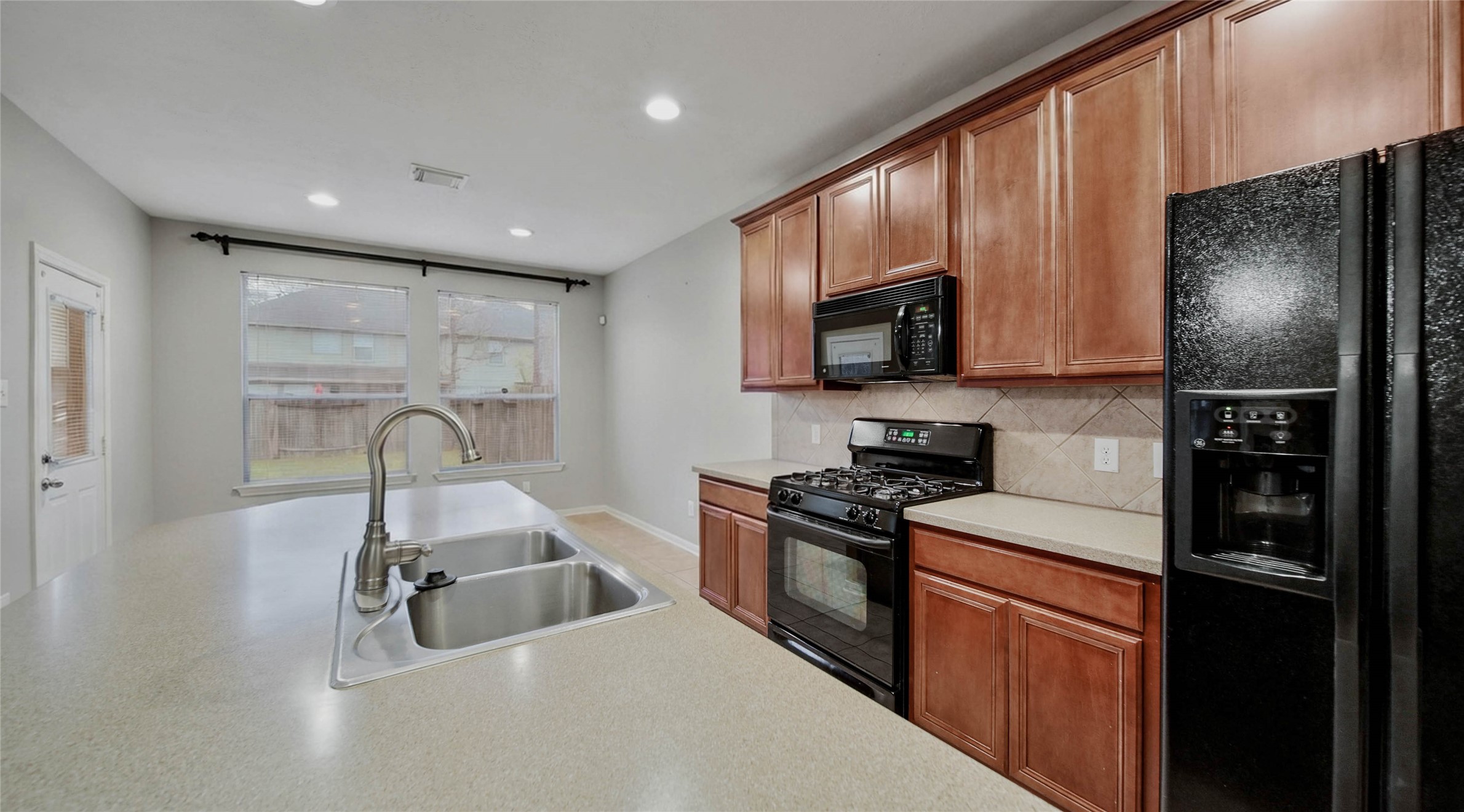 87 West Twinvale Loop Conroe, TX 77384 - Photo 9 of 19 a kitchen with stainless steel appliances granite countertop a refrigerator stove top oven a sink and dishwasher