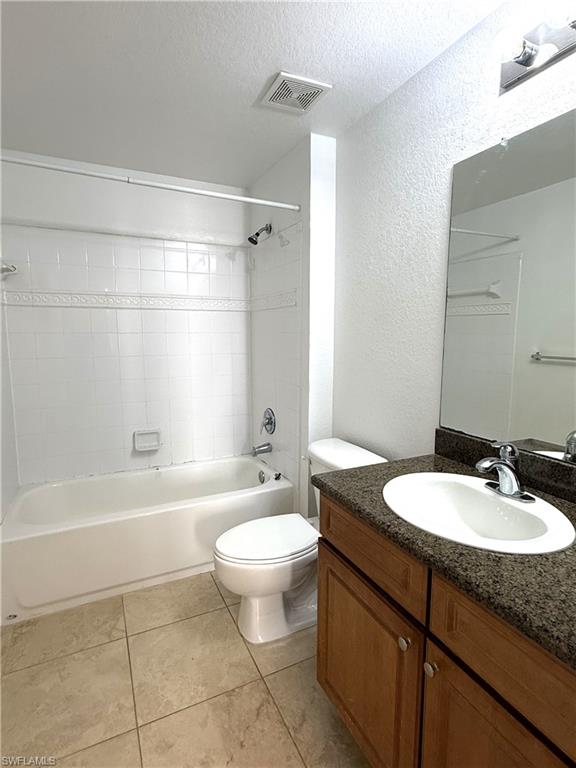 12990 Positano Circle, Unit 208 Naples, FL 34105 - Photo 6 of 20 a bathroom with a granite countertop sink toilet a mirror and bathtub