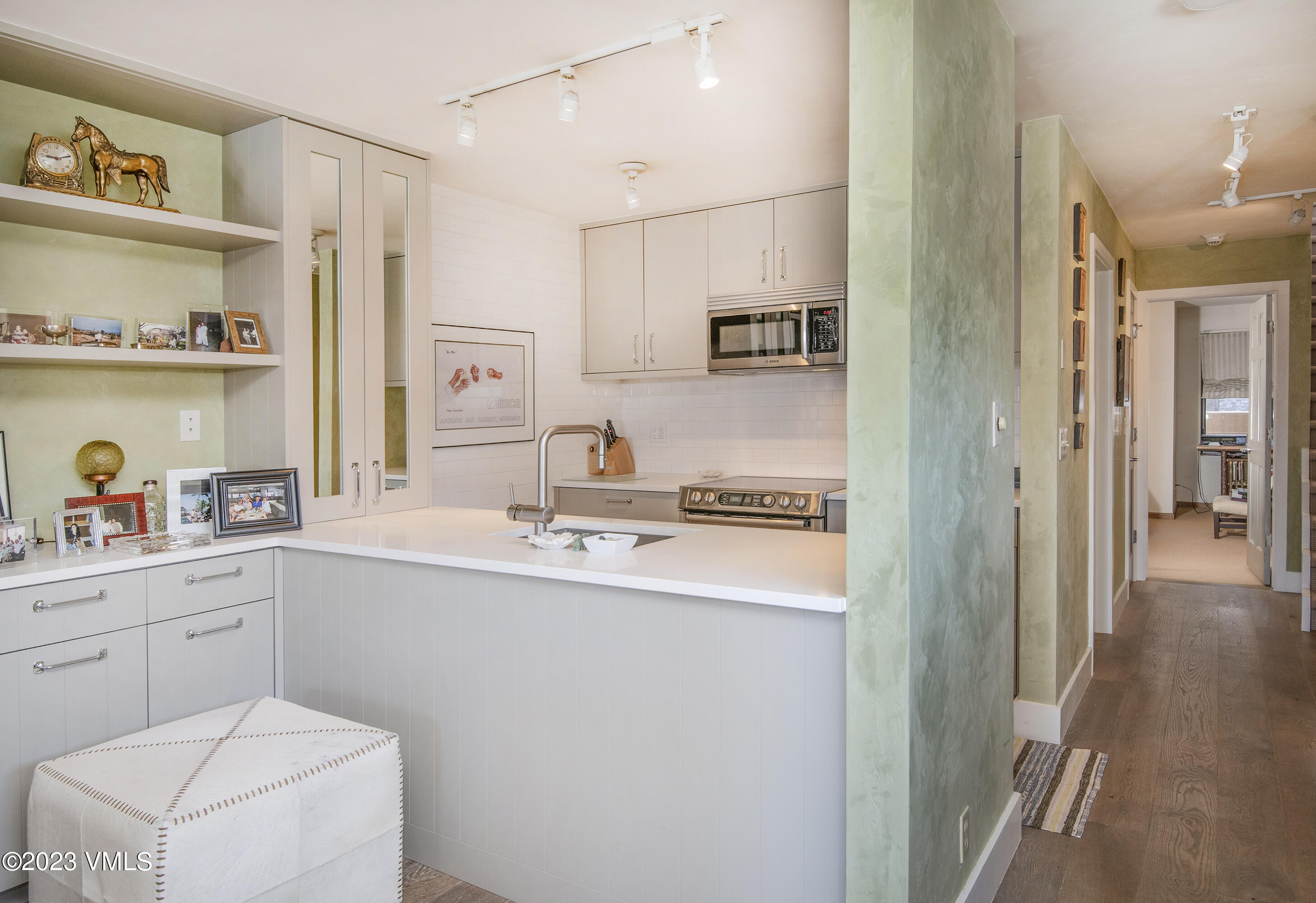 137 Benchmark Road, Unit 327 Avon, CO 81620 - Photo 12 of 43 a kitchen with stainless steel appliances a sink a refrigerator and cabinets