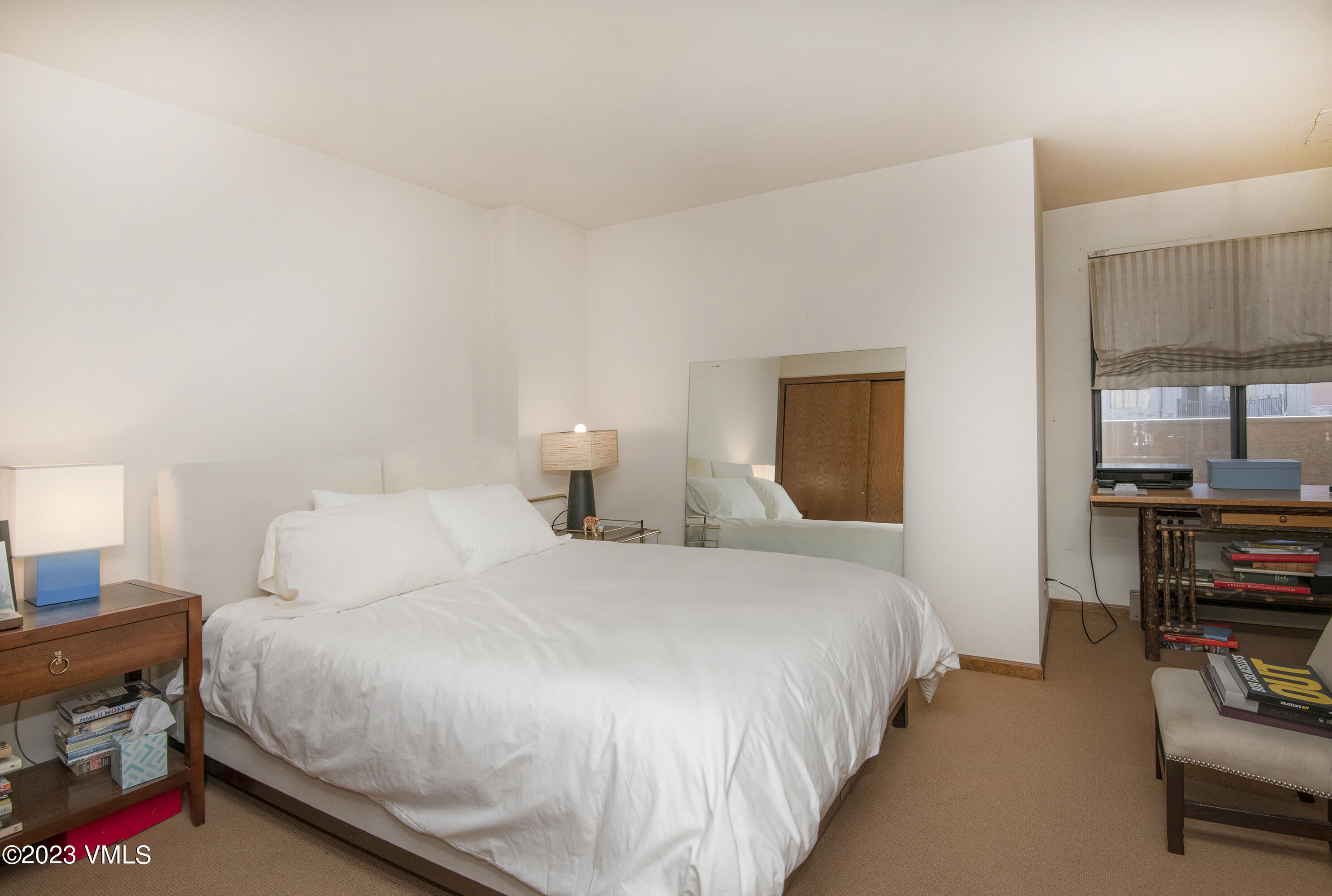 137 Benchmark Road, Unit 327 Avon, CO 81620 - Photo 19 of 43 a bedroom with bed and a book shelf