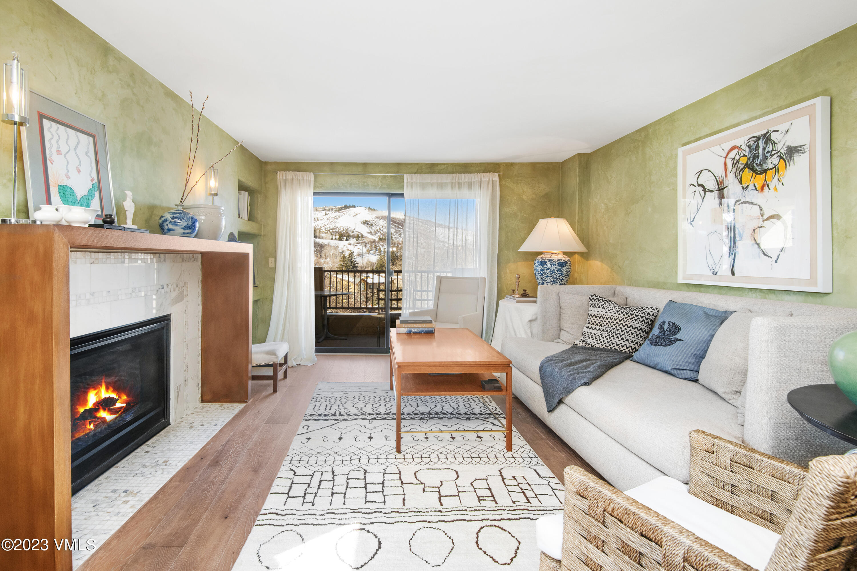 137 Benchmark Road, Unit 327 Avon, CO 81620 - Photo 2 of 43 a living room with furniture and a fireplace