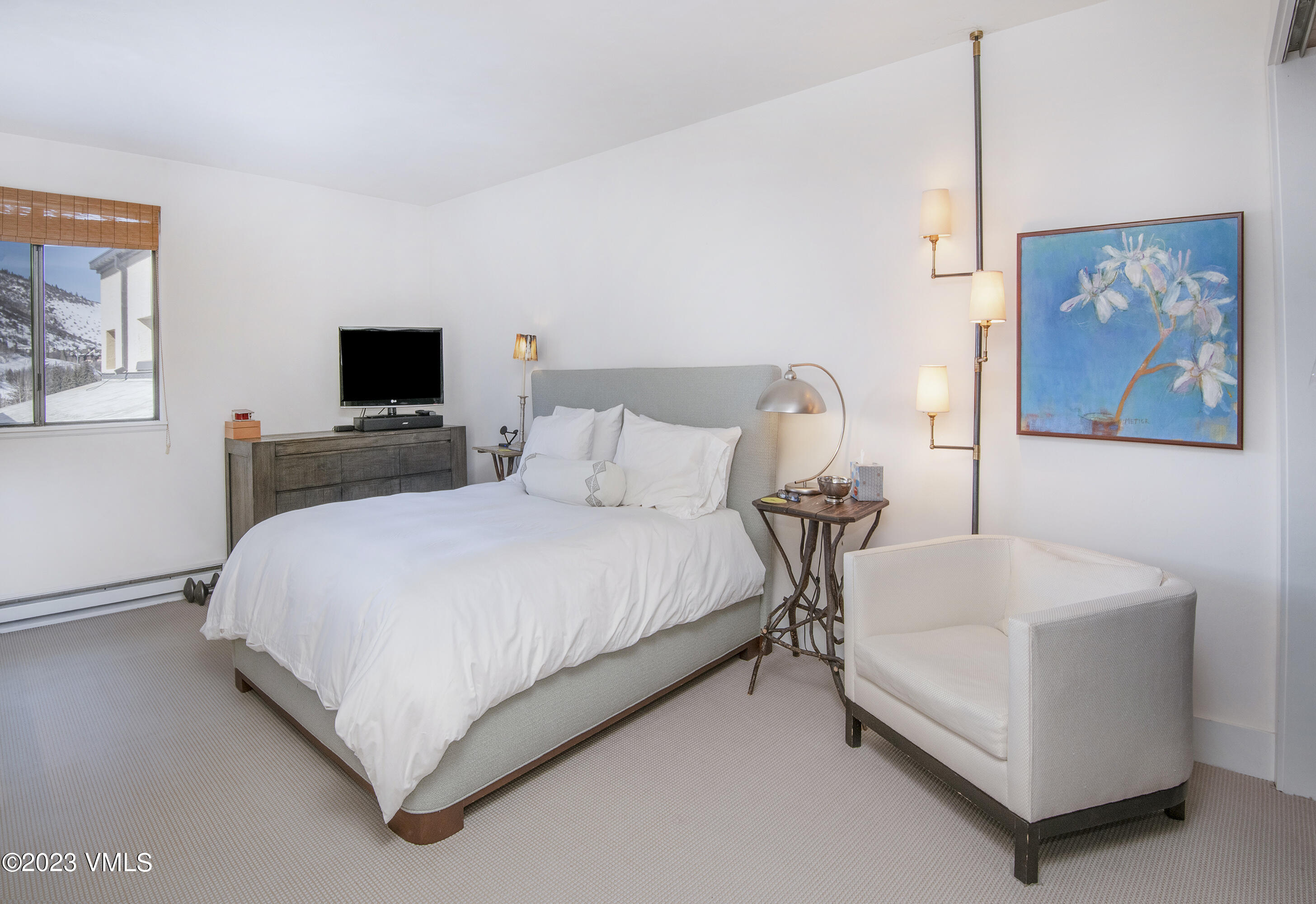 137 Benchmark Road, Unit 327 Avon, CO 81620 - Photo 23 of 43 a bedroom with a bed and a flat screen tv