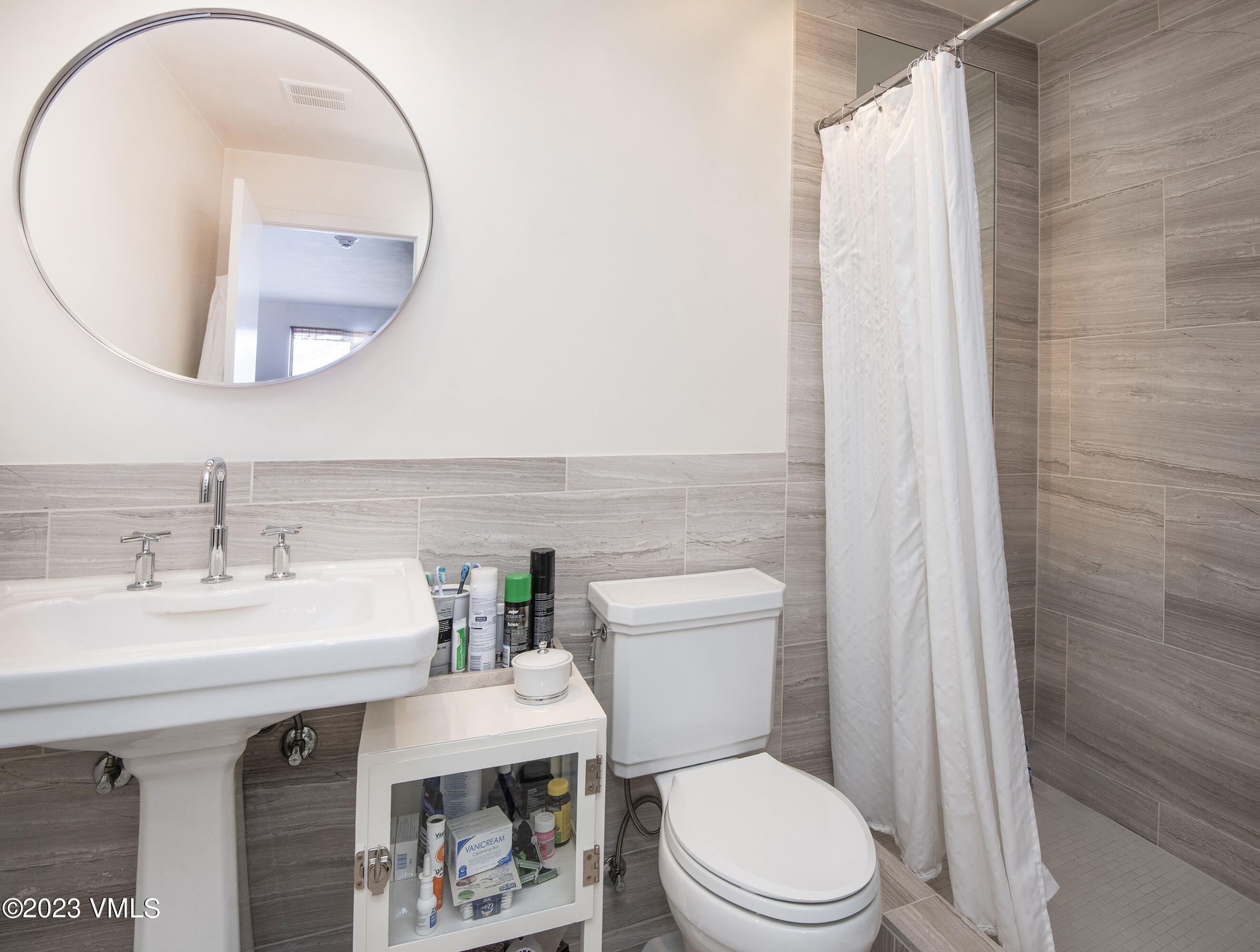 137 Benchmark Road, Unit 327 Avon, CO 81620 - Photo 27 of 43 a bathroom with a sink a toilet and a mirror