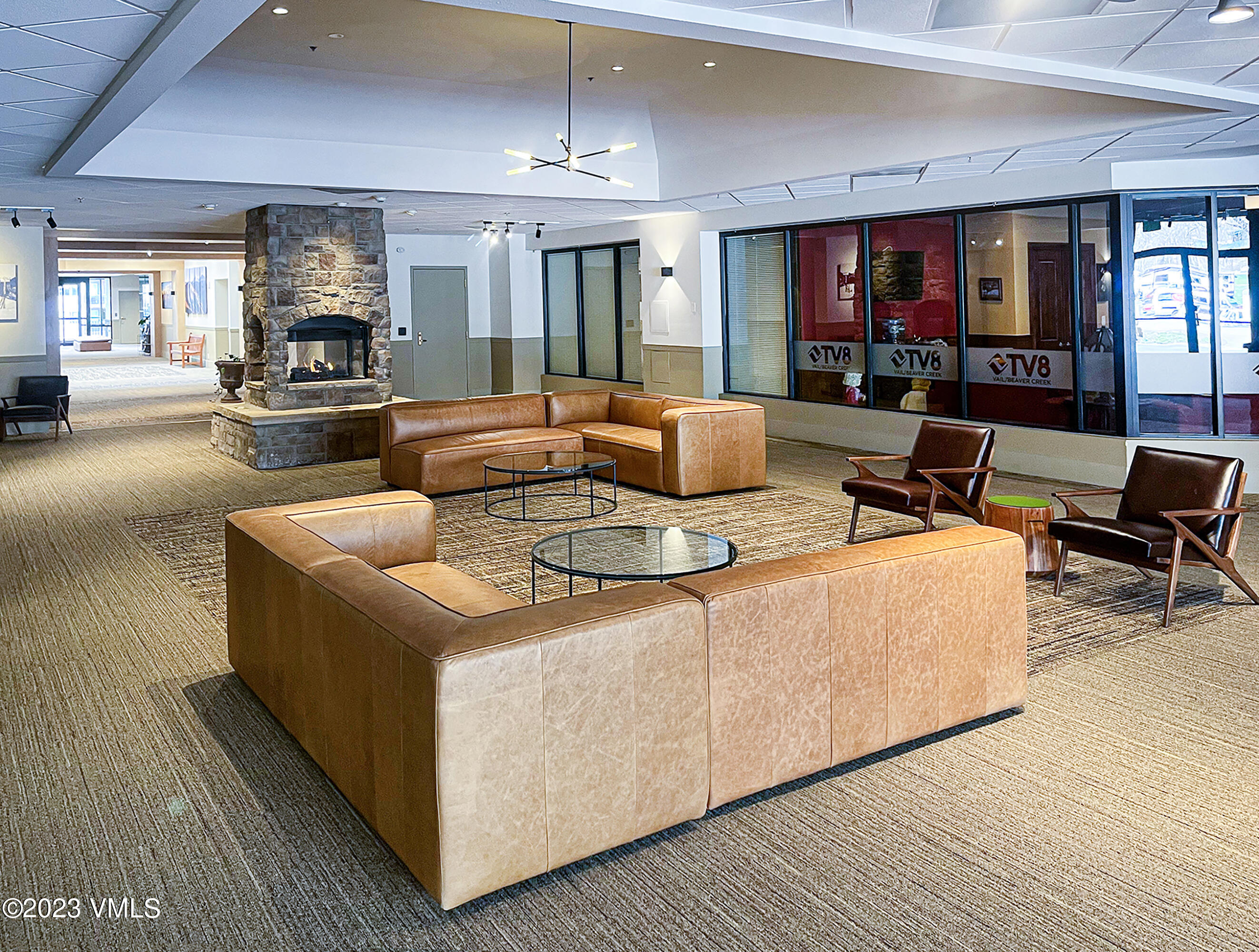 137 Benchmark Road, Unit 327 Avon, CO 81620 - Photo 30 of 43 a living room with furniture and a flat screen tv