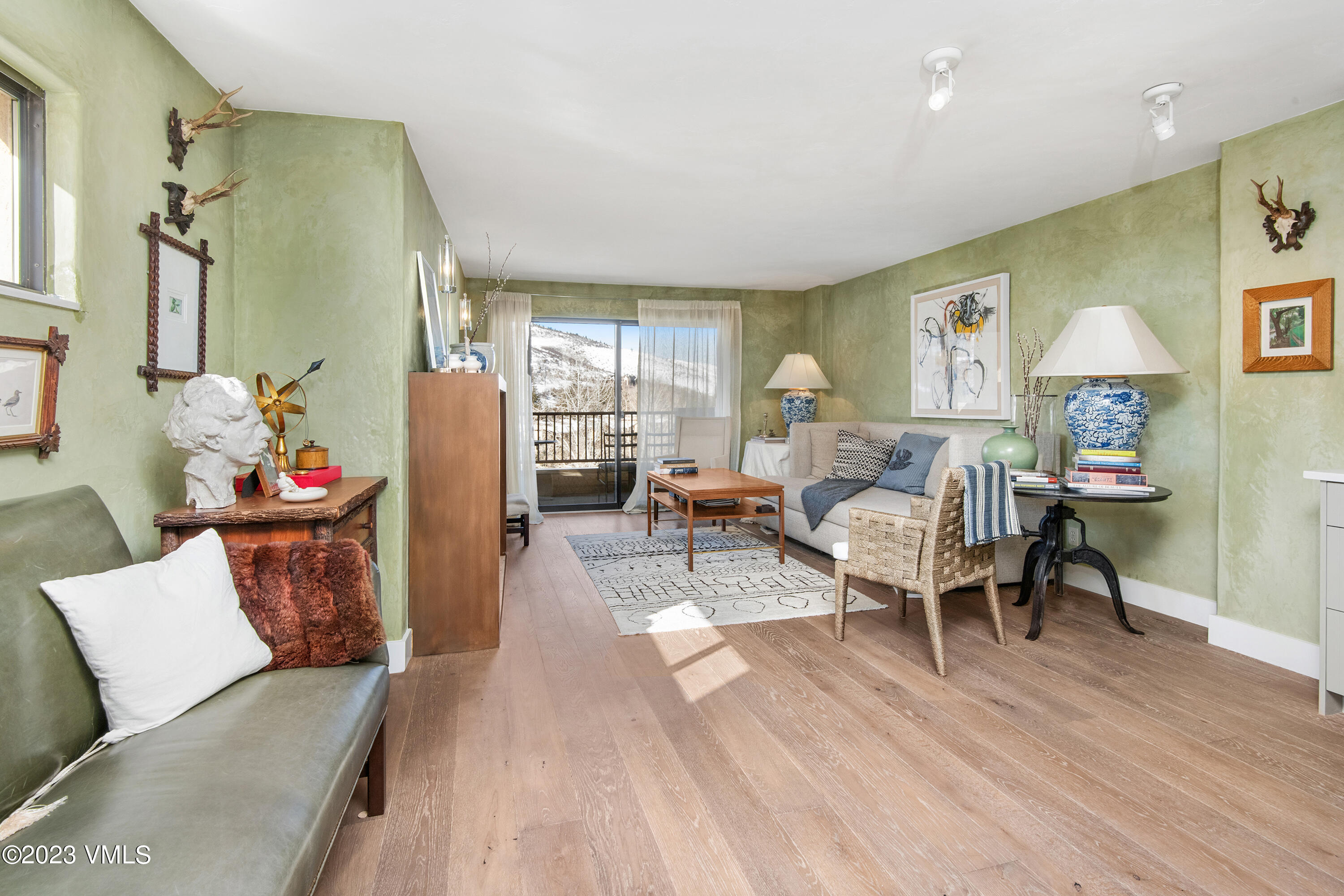 137 Benchmark Road, Unit 327 Avon, CO 81620 - Photo 3 of 43 a living room with furniture and a wooden floor