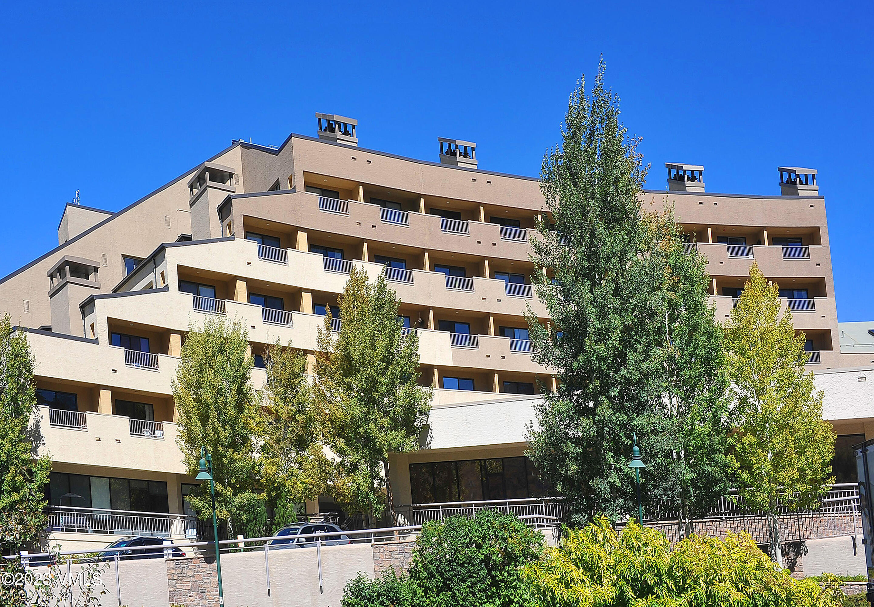 137 Benchmark Road, Unit 327 Avon, CO 81620 - Photo 37 of 43 a view of a building with a yard and plants