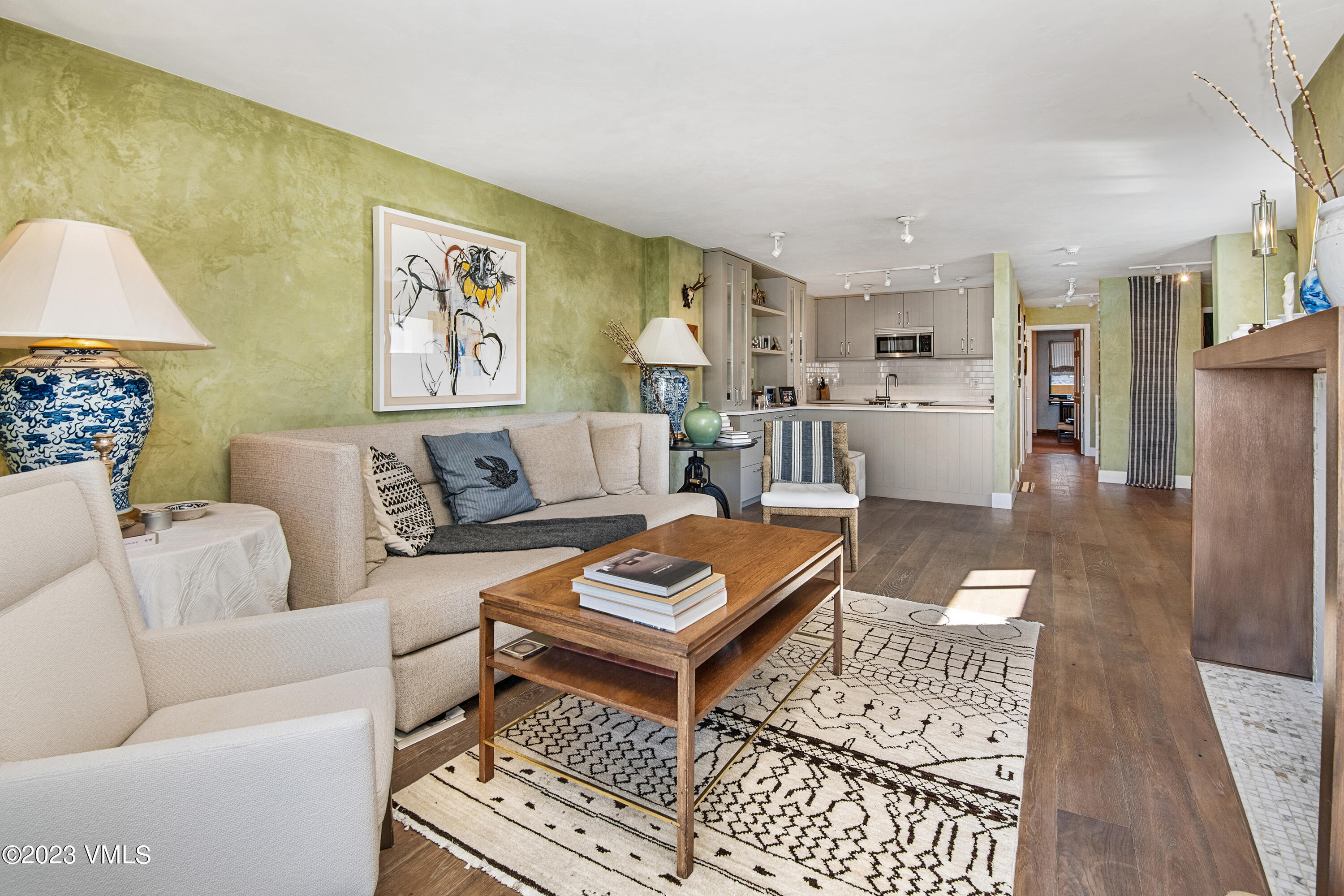 137 Benchmark Road, Unit 327 Avon, CO 81620 - Photo 7 of 43 a living room with furniture a rug and a lamp