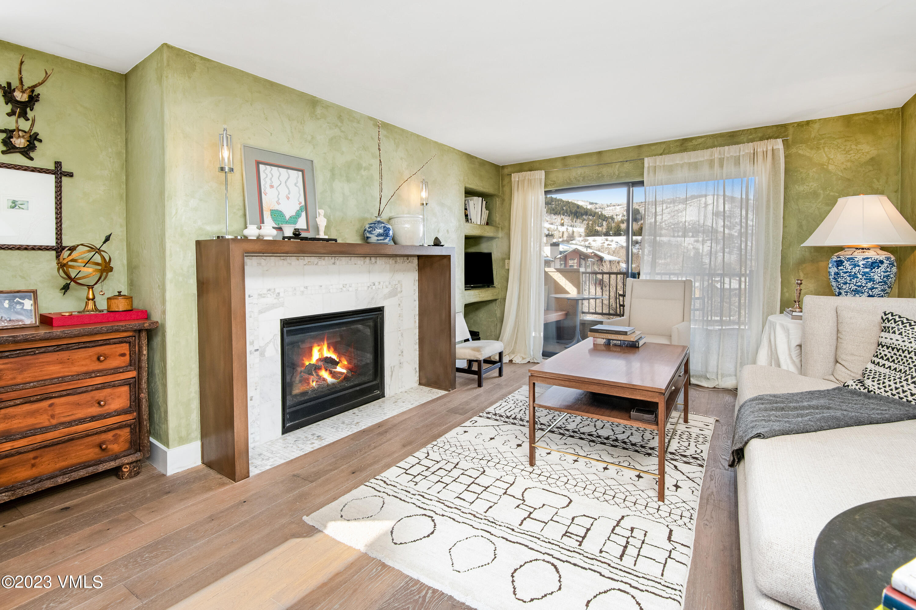 137 Benchmark Road, Unit 327 Avon, CO 81620 - Photo 9 of 43 a living room with furniture a flat screen tv and a fireplace