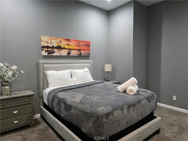 a bedroom with a bed and a wall painting