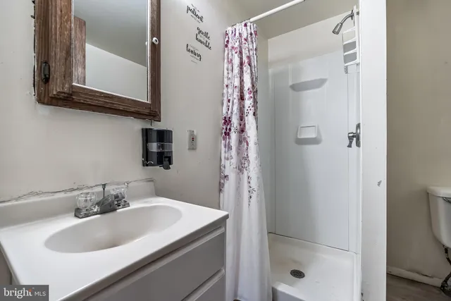 a kitchen with stainless steel appliances a stove top oven a refrigerator and cabinets