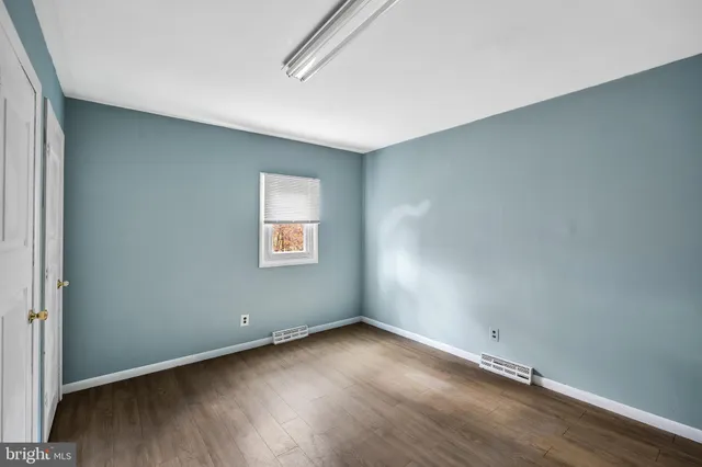an empty room with a empty space and windows