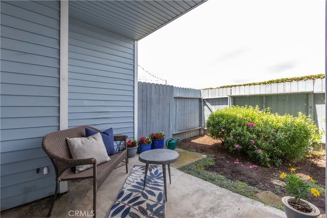a backyard of a house with table and chairs