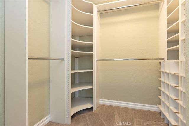 a view of a walk in closet with empty racks