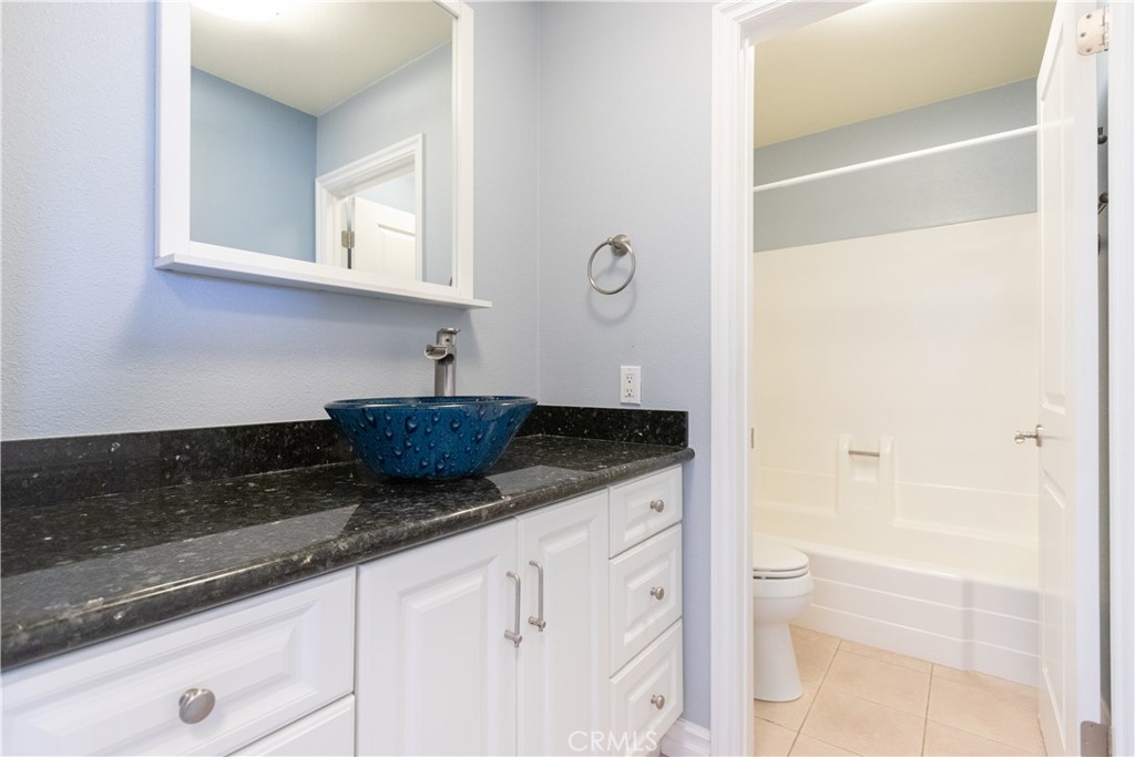 24601 B Harbor View Drive Dana Point, CA 92629 - Photo 25 of 36 a bathroom with a granite countertop sink a toilet and bathtub