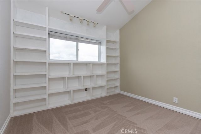 a view of a room with shelf on the wall