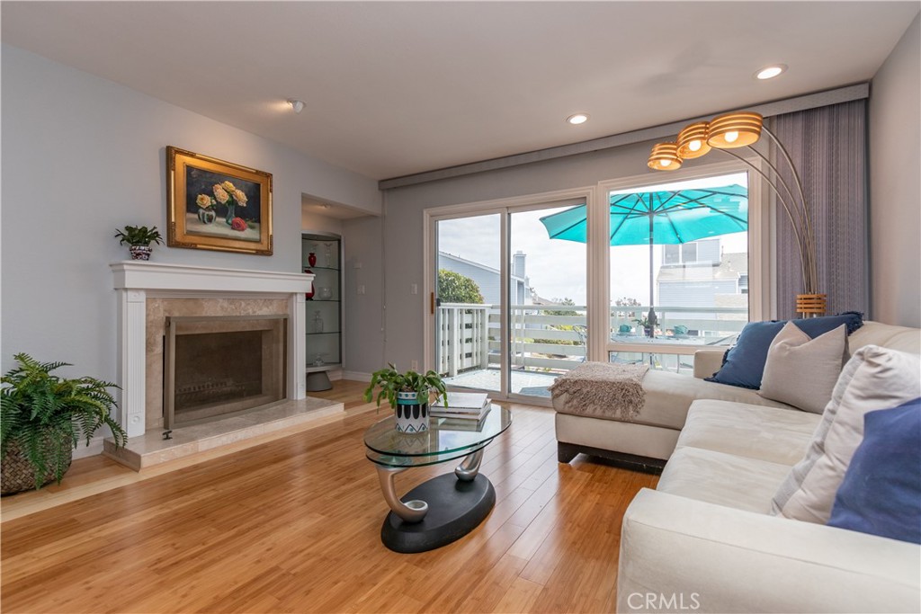 24601 B Harbor View Drive Dana Point, CA 92629 - Photo 6 of 36 a living room with furniture a fireplace and a large window