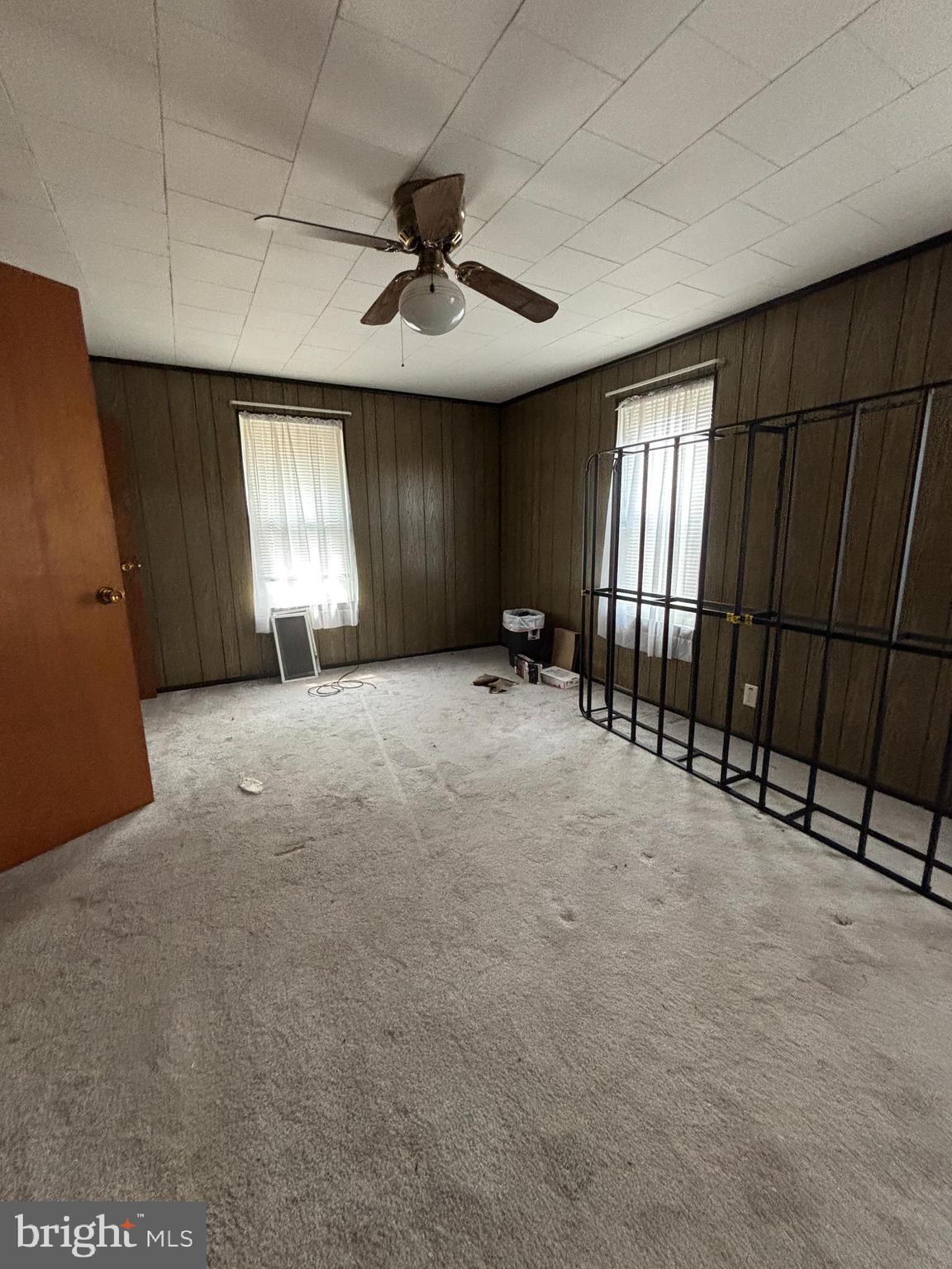 488 State Street Sandy Ridge, PA 16677 - Photo 27 of 36 en empty room with windows and ceiling fan