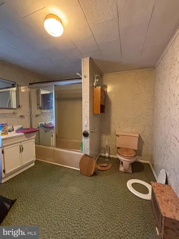 a view of a porch with a table and chairs