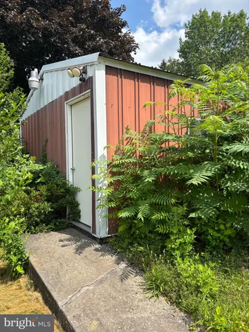 a front view of house with yard and trees in the background