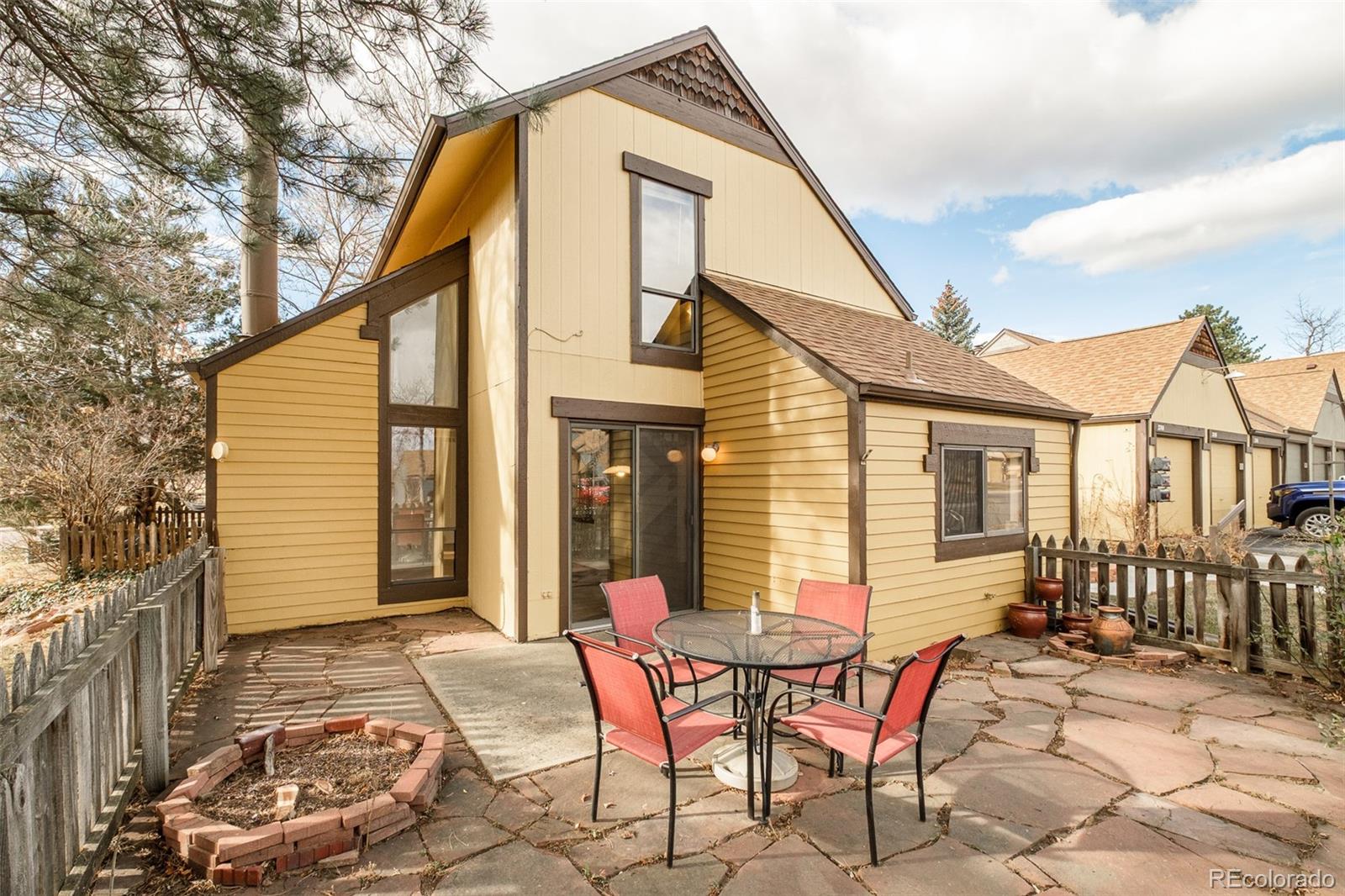 a view of a house with backyard and sitting area