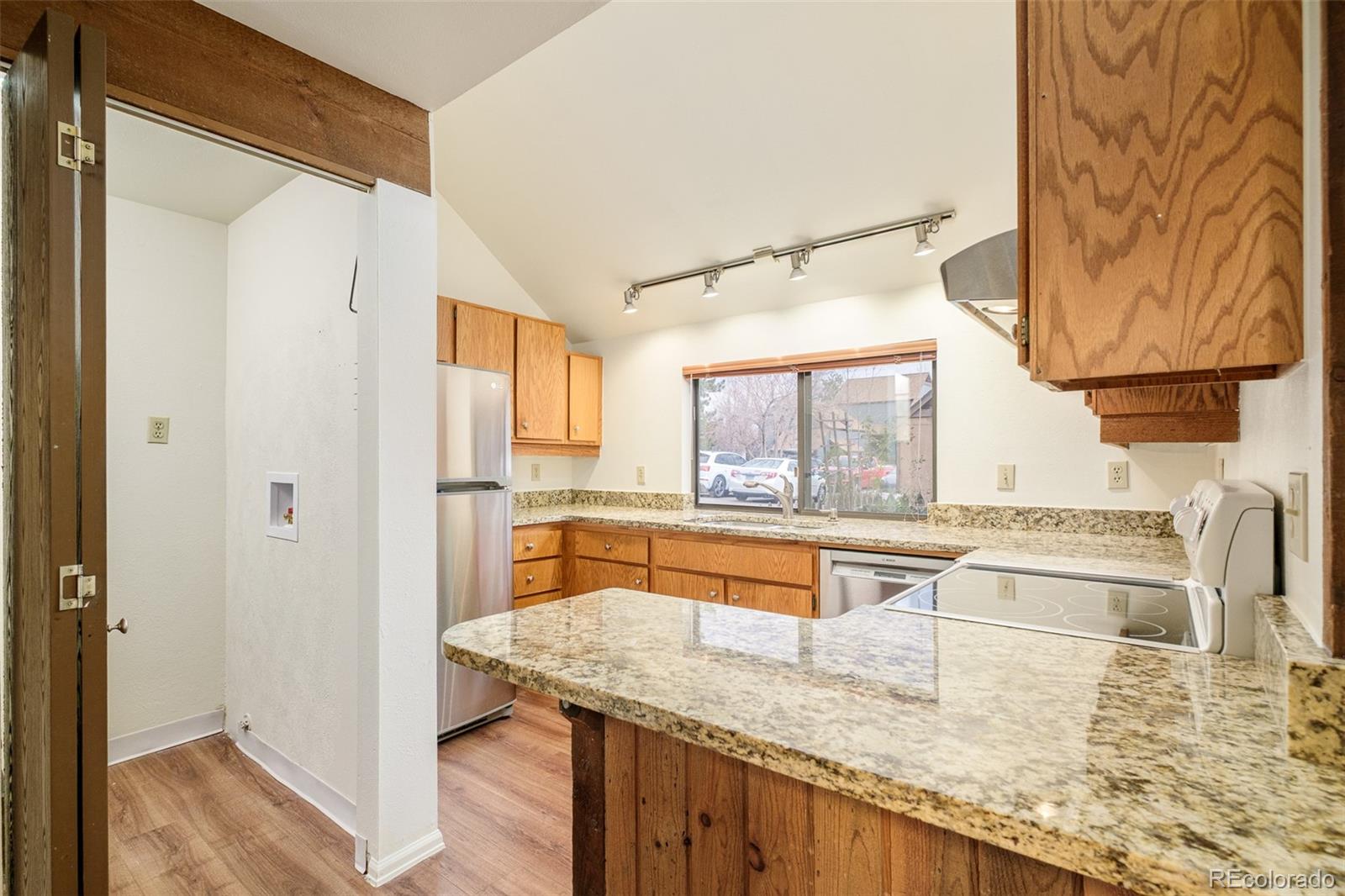 3760 Smuggler Place Boulder, CO 80305 - Photo 13 of 40 a kitchen with stainless steel appliances granite countertop a sink and a refrigerator