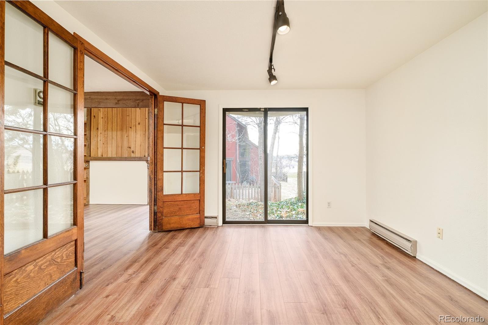 3760 Smuggler Place Boulder, CO 80305 - Photo 14 of 40 a view of empty room with wooden floor and fan