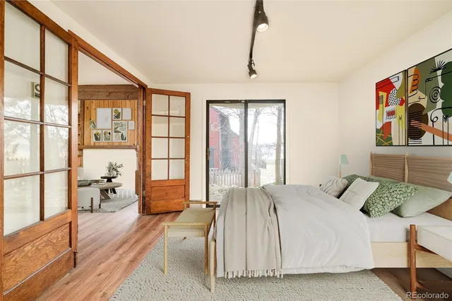 a bedroom with a bed and a large window