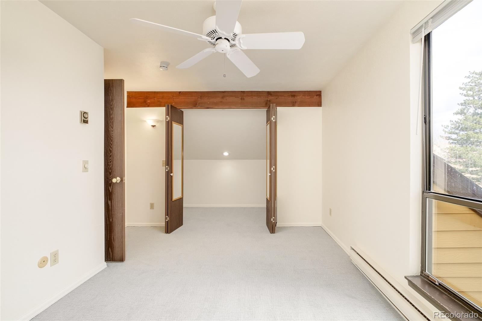 3760 Smuggler Place Boulder, CO 80305 - Photo 27 of 40 a view of a livingroom with a ceiling fan and window