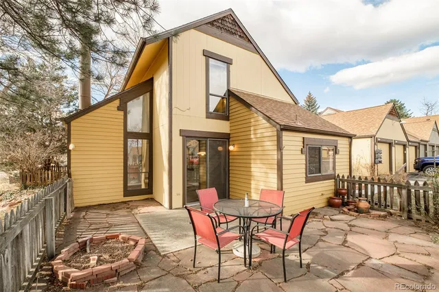a view of a house with backyard and sitting area