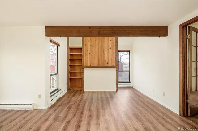 a view of walk in closet with wooden floor