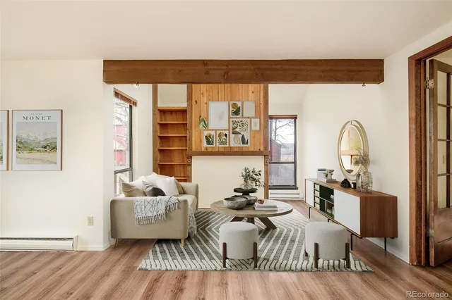 a living room with furniture window and wooden floor