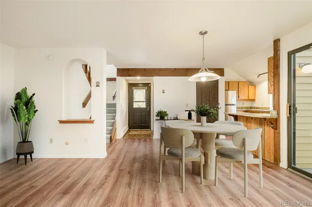 a view of a dining room with furniture window and wooden floor