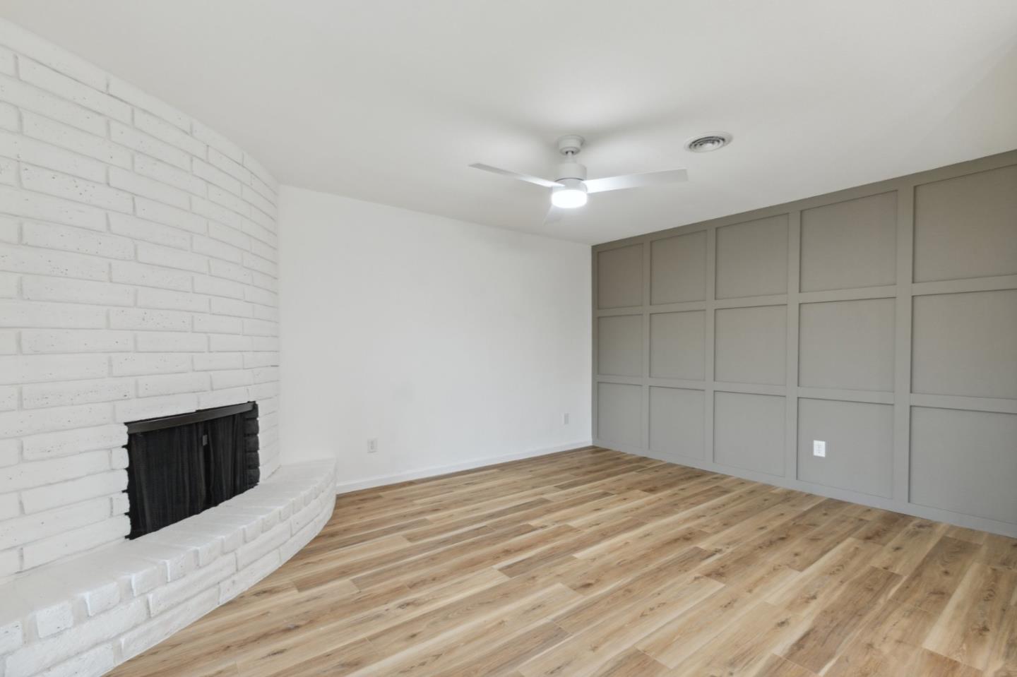 1413 Clevenger Drive Modesto, CA 95356 - Photo 12 of 37 a view of empty room with wooden floor and fireplace
