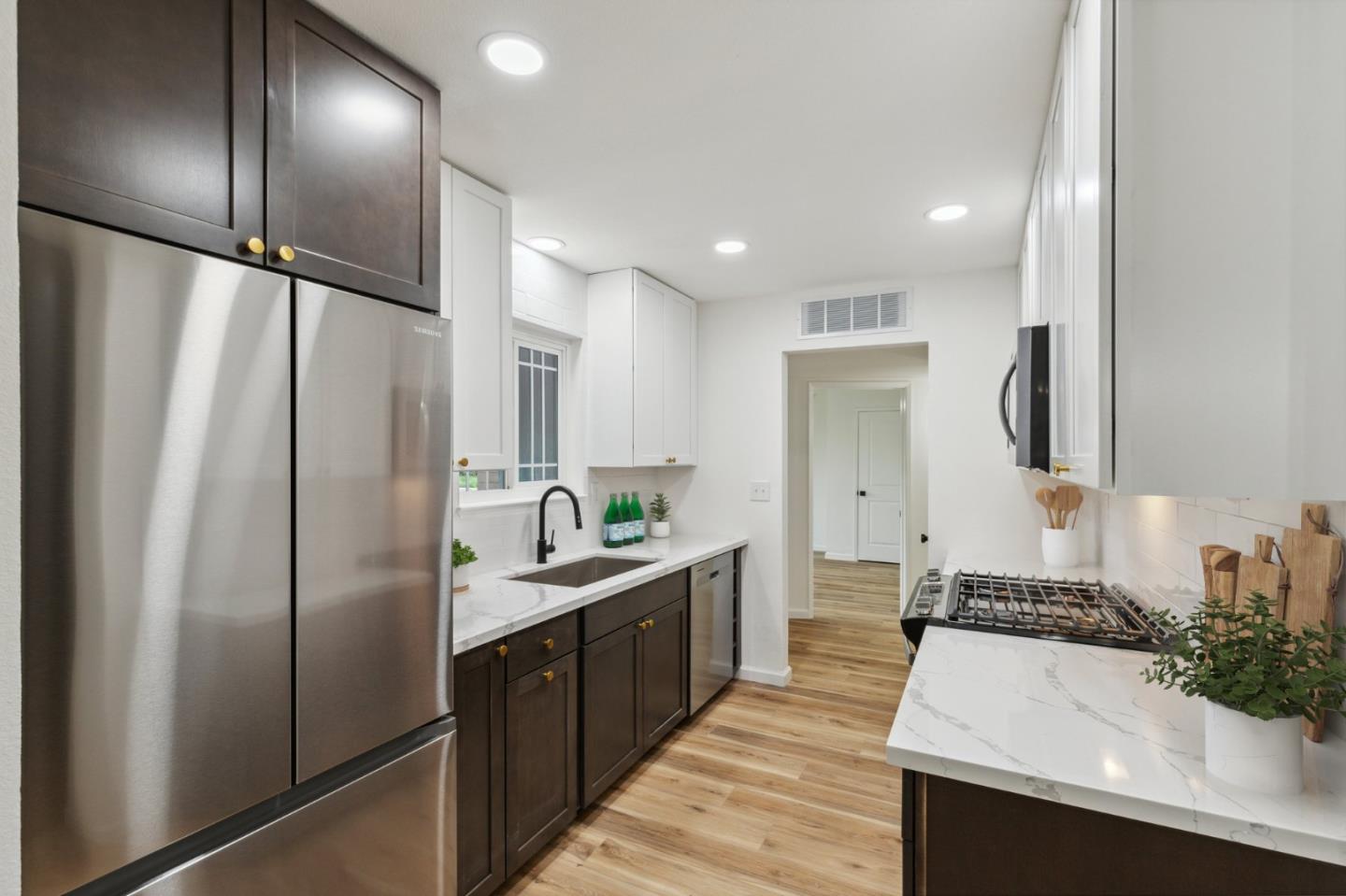 1413 Clevenger Drive Modesto, CA 95356 - Photo 19 of 37 a kitchen with stainless steel appliances a sink and a refrigerator