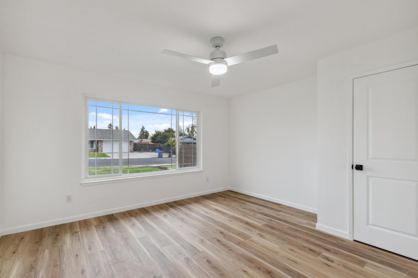 1413 Clevenger Drive Modesto, CA 95356 - Photo 21 of 37 an empty room with wooden floor and windows