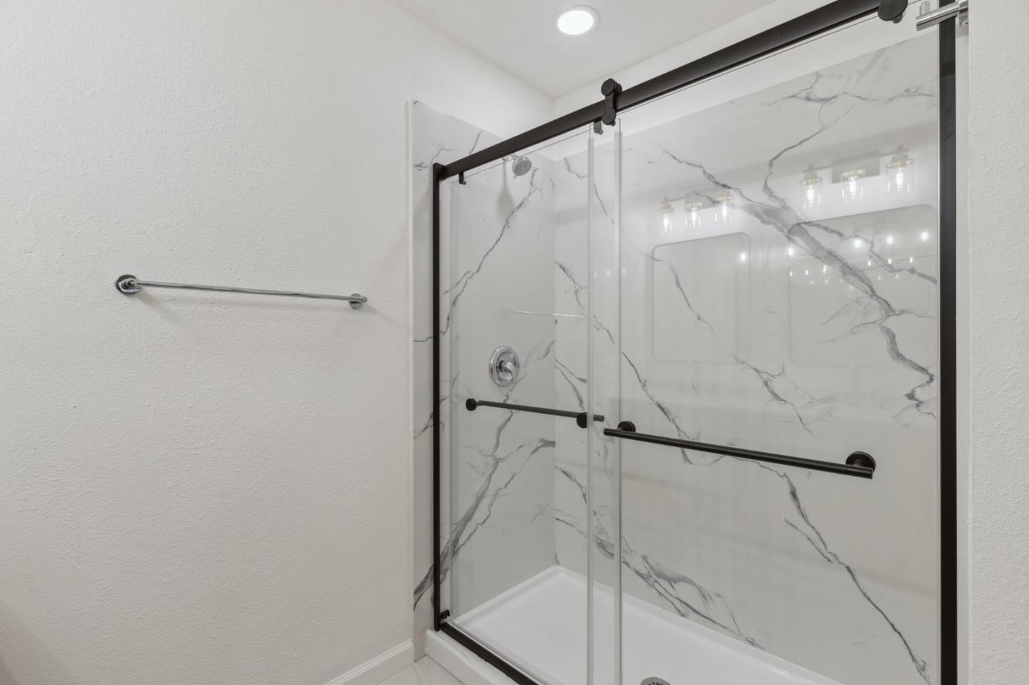 1413 Clevenger Drive Modesto, CA 95356 - Photo 30 of 37 a bathroom with a glass shower door