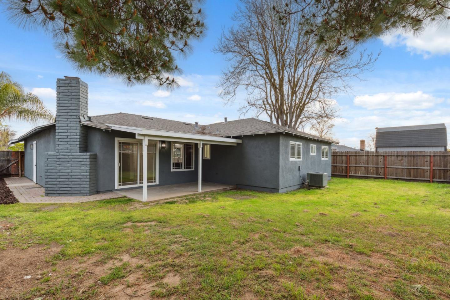 1413 Clevenger Drive Modesto, CA 95356 - Photo 35 of 37 a view of a house with a yard and large tree