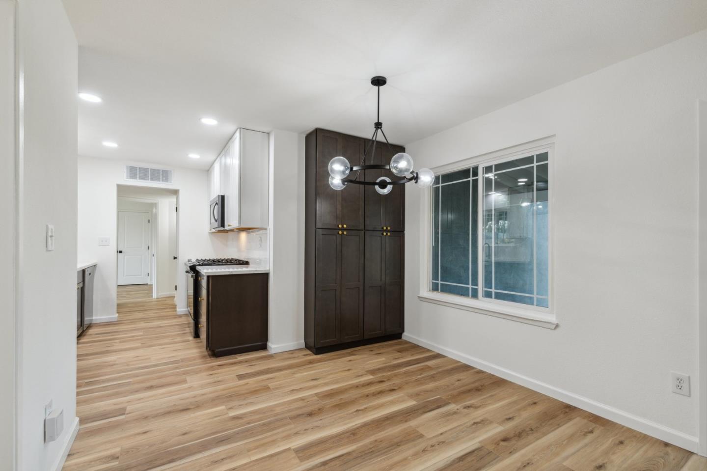 1413 Clevenger Drive Modesto, CA 95356 - Photo 8 of 37 a view of an empty room with a kitchen and a window