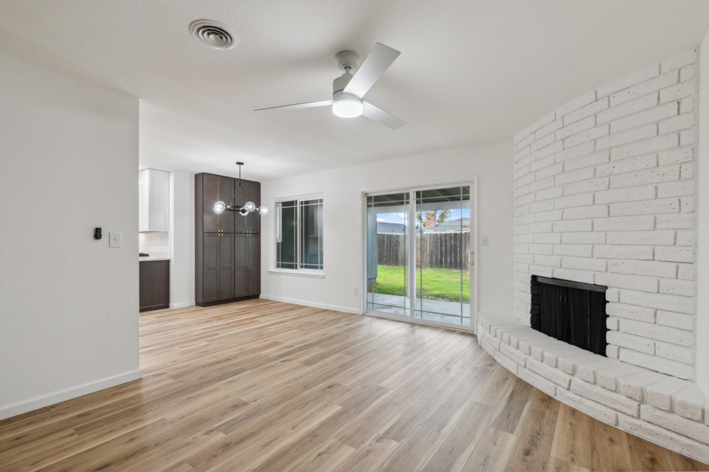 1413 Clevenger Drive Modesto, CA 95356 - Photo 10 of 37 a view of empty room with wooden floor and fireplace
