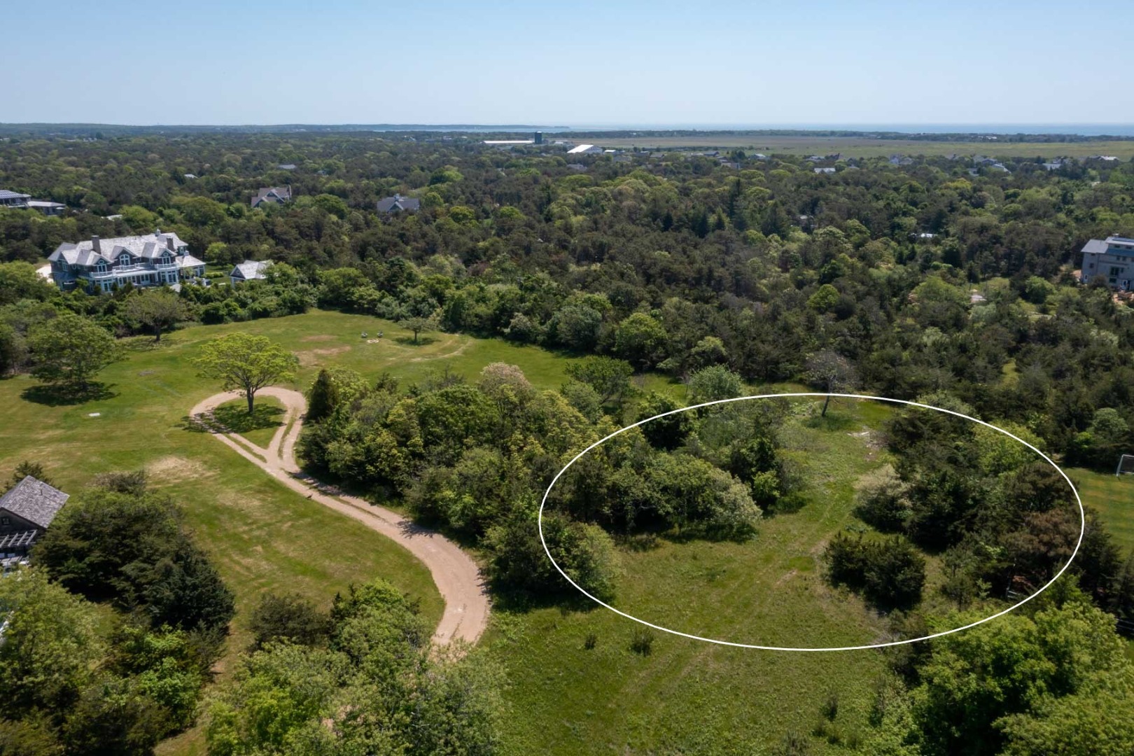 29 Slough Cove Road Edgartown, MA 02539 - Photo 3 of 8 an aerial view of a house with a yard and lake view