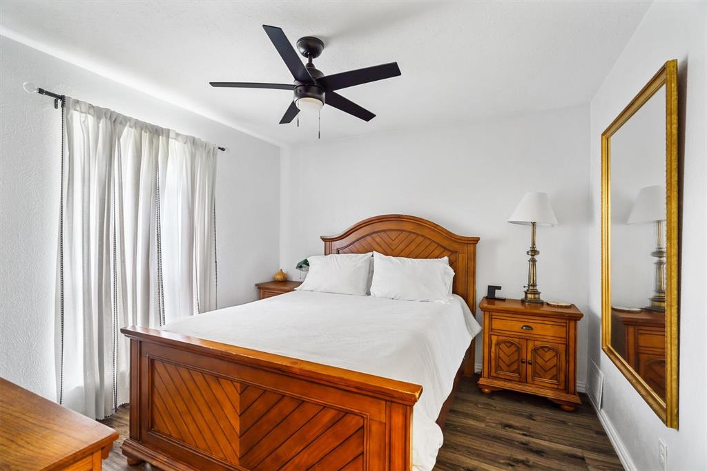2214 Valley Mill Carrollton, TX 75006 - Photo 29 of 36 a bedroom with a bed and wooden floor