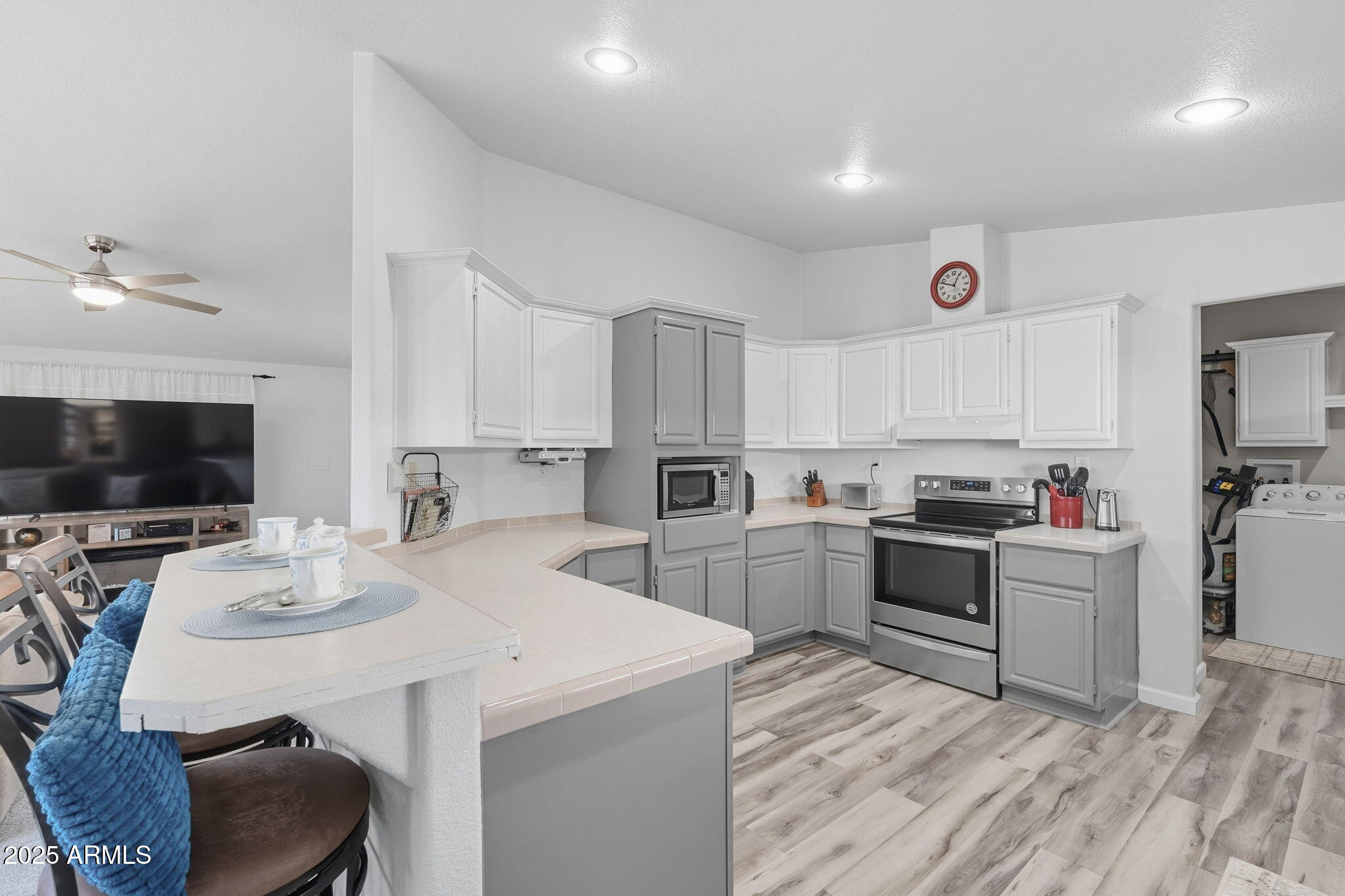 3700 South Tomahawk Road, Unit 39 Apache Junction, AZ 85119 - Photo 21 of 53 a kitchen with cabinets a sink and a stove