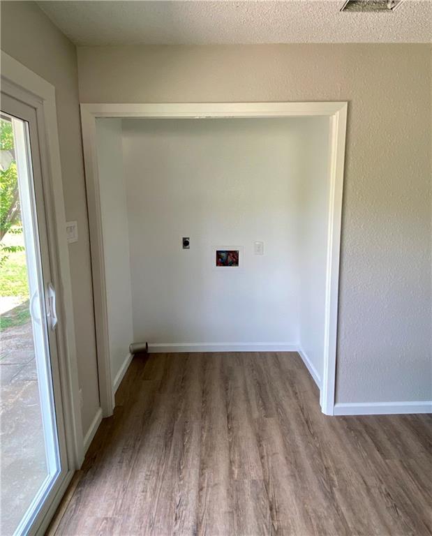 1715 Shadowview Drive, Unit B Austin, TX 78758 - Photo 19 of 28 A dedicated laundry nook with wood flooring and convenient hookups awaits customization.