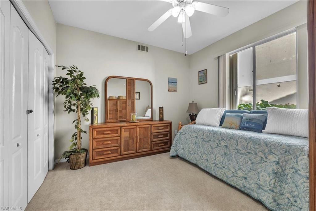 8075 Tiger Cove, Unit 1706 Naples, FL 34113 - Photo 22 of 50 Bedroom with carpet flooring, a closet, and a ceiling fan
