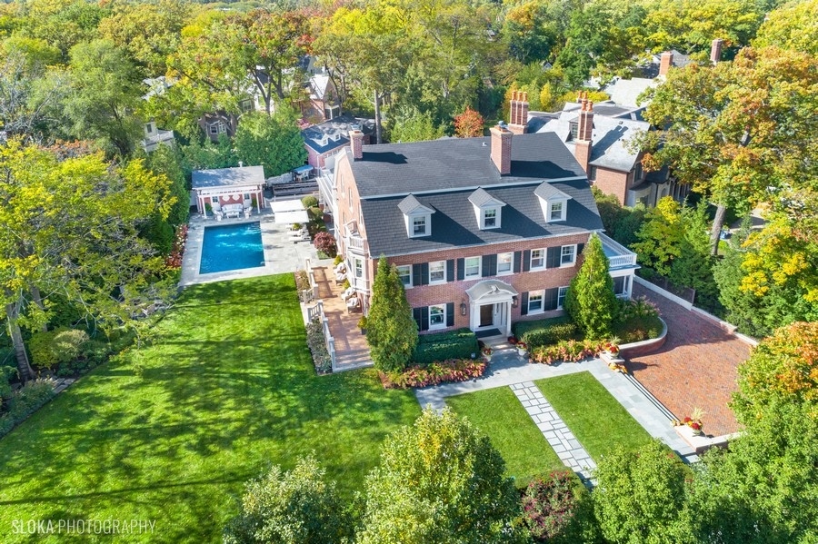 660 Prospect Avenue Winnetka, IL 60093 - Photo 1 of 77 a view of a big house with a big yard plants and large trees